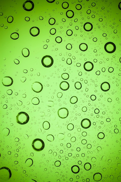 Texture water drops on green glass.