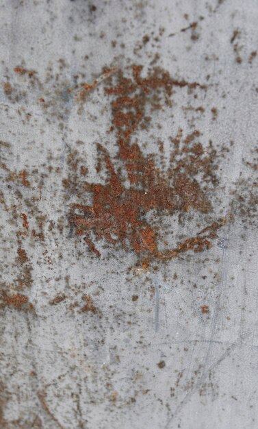 Photo texture of a white metal sheet with rust in the centre