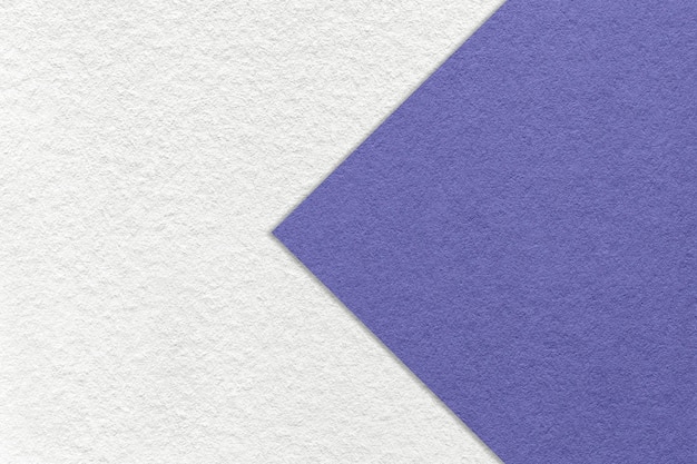 Texture of white paper background half two colors with very peri arrow macro Structure of craft violet cardboard