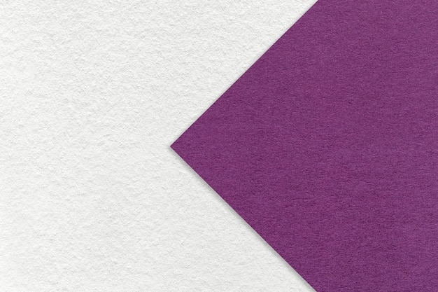 Texture of white paper background half two colors with violet arrow macro