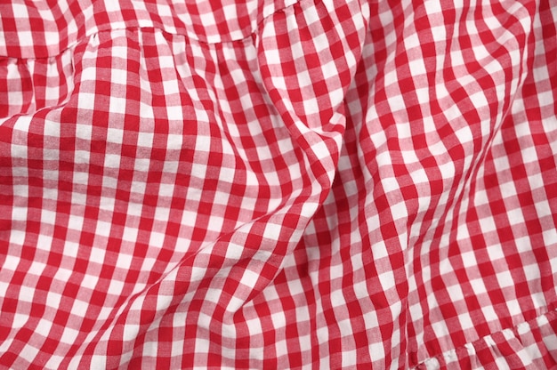 Texture of white-red crumpled fabric in a cage. High quality photo