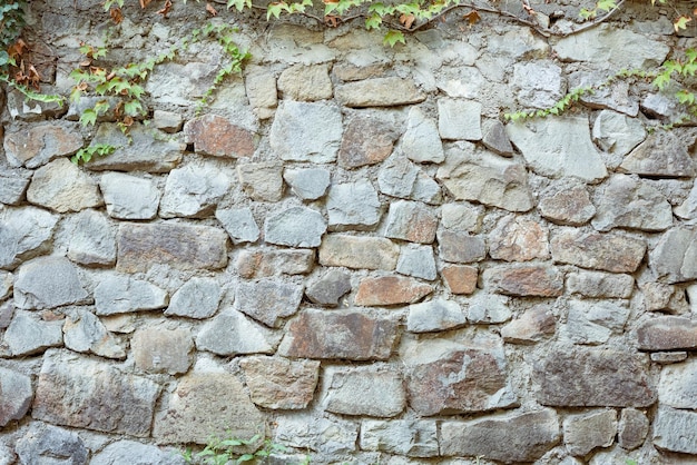 Textured background irregular natural stone wall made of different stones