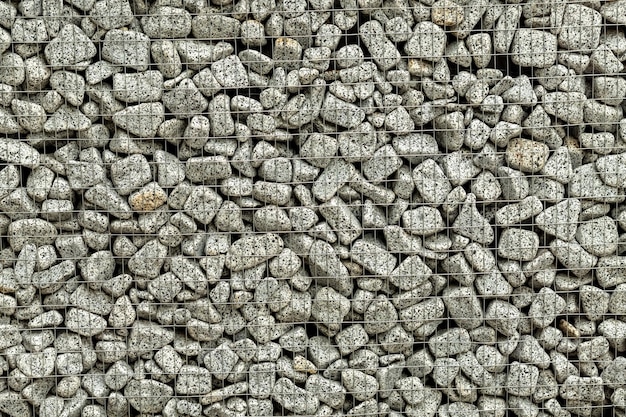 Textured background of a stone wall with iron netting