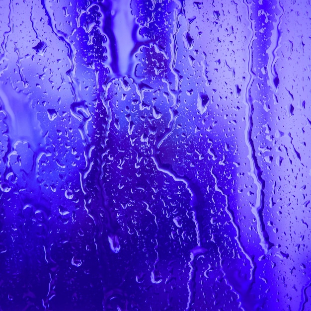 Textured background of water droplets on colored background