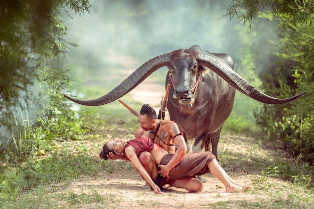 Thai ancient warrior holding a two-handed sword and long horn buffalo