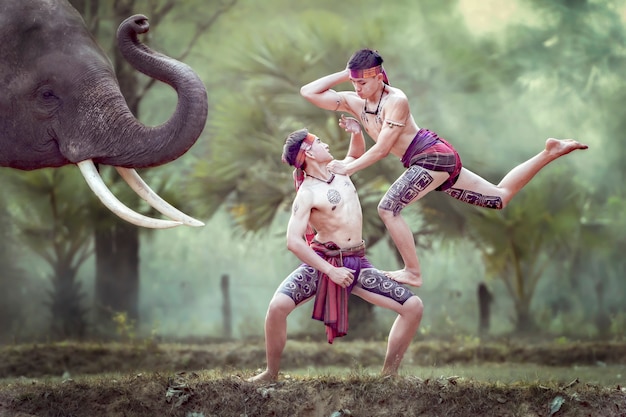 Thai boys practicing ancient boxing dances before the elephants, which is one of the arts of the Thai people.