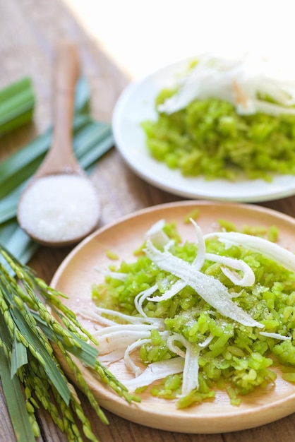 Thai dessert pounded unripe rice food rice flakes cereal with coconut and sugar Green rice sweet with ears of rice pandan leaf Food dessert or snacks Khao Mao name in Thailand