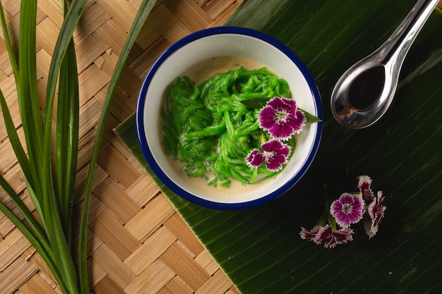 Thai dessert, rice noodles made of rice eaten with coconut milk on wooden table, Top view