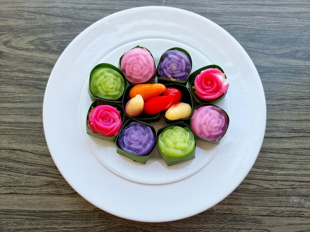 Thai desserts on a white plate such as Deletable Imitation Fruits Khanom Look Choup and Khanom Alua