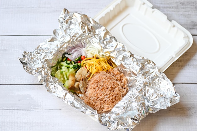 Thai food on box with aluminum foil food wrap takeaway food rice mixed with shrimp paste fried rice on boxrice seasoned with shrimp paste recipe rice herbal spices