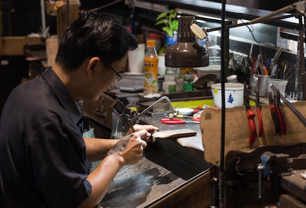 Thai jeweler making fine jewelry in a workshop