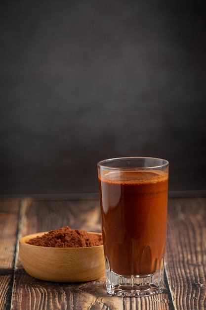 Thai milk tea and cocoa in bottle on wood table