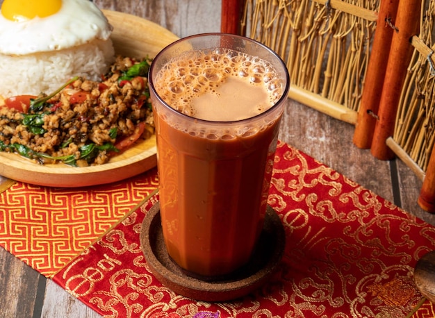 Thai milk tea served in glass isolated on table side view of taiwan food