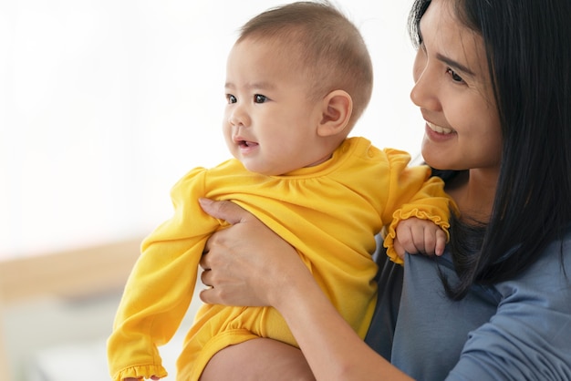 Thai mum is comforting a baby. woman holding a newborn baby in her arms