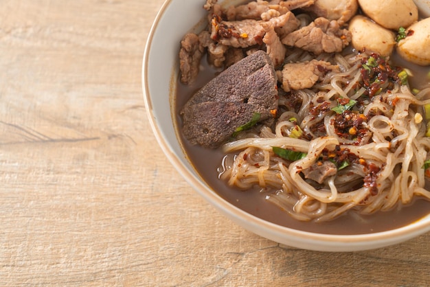 Thai noodle with pork stewed pork meatball and pork liver in blood soup