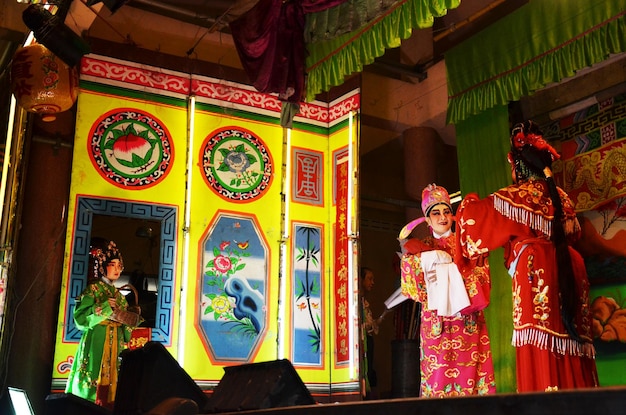 Thai people of chinese descent acting playing present traditional chinese contemporary classical opera for show local people in happy new years festival at city on March 13 2011 in Bangkok Thailand