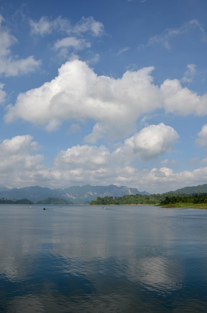 Thai people sail long tail boat serviced for sending and receive people travel in Cheow Lan Lake at Ratchaprapa or Rajjaprabha Dam Reservoir in Khao Sok National Park in Surat Thani Province Thailand