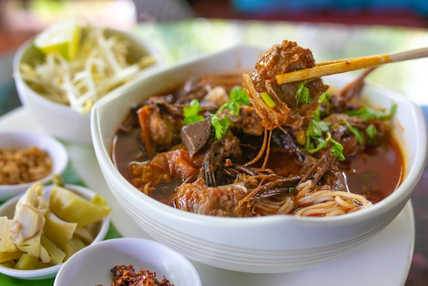 Thai rice noodles with (northern) Lanna curry called nam ngio. Thai food.