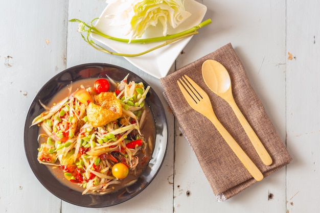 Thai spicy papaya salad serve with vegetables