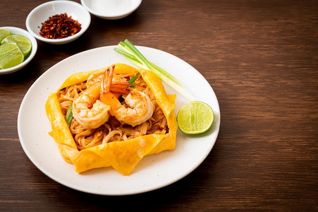 Thai stir fried noodles with shrimps and egg wrap Pad Thai