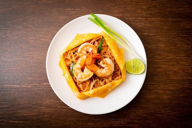 Thai stir fried noodles with shrimps and egg wrap Pad Thai