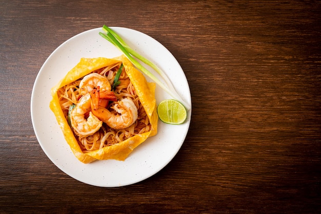 Thai stir fried noodles with shrimps and egg wrap Pad Thai