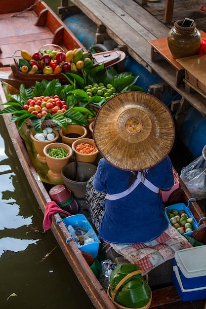 Thai woman selling food on boat at floating market in Thailand