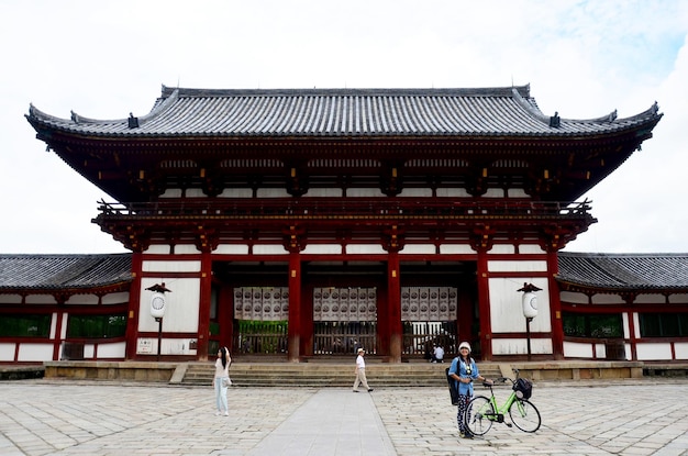 Thai women travellers posing with bicycle and visit this measure has been registered as World Heritage Site at Todaiji Temple on July 9 2015 in Nara Japan