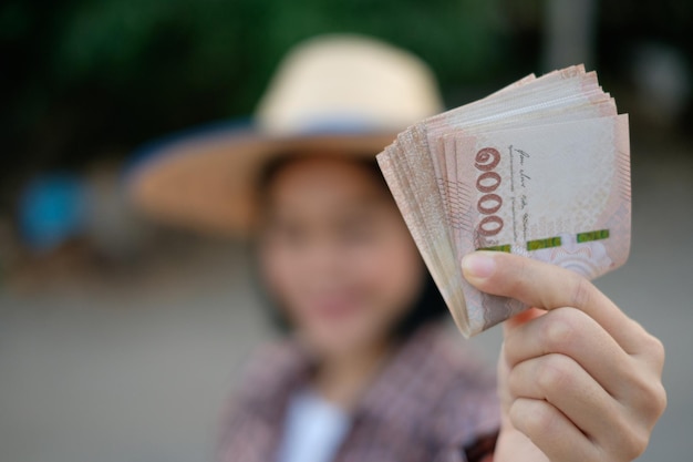 Thailand banknote money holded by asian farmer hand