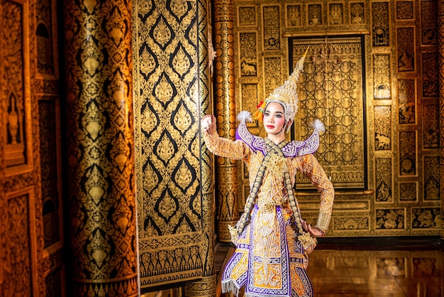 Thailand typical dancer with typical clothes on gold walls background