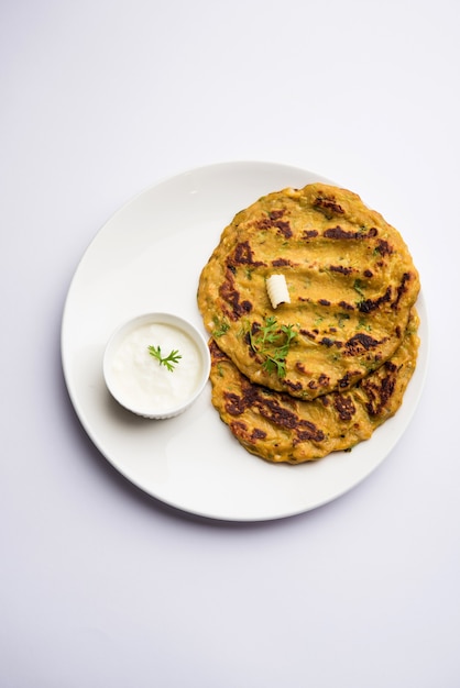 Thalipeeth is a type of savoury multi-grain pancake popular in Maharashtra, India served with curd, butter or ghee