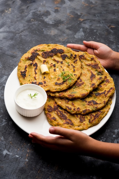 Thalipeeth is a type of savoury multi-grain pancake popular in Maharashtra, India served with curd, butter or ghee