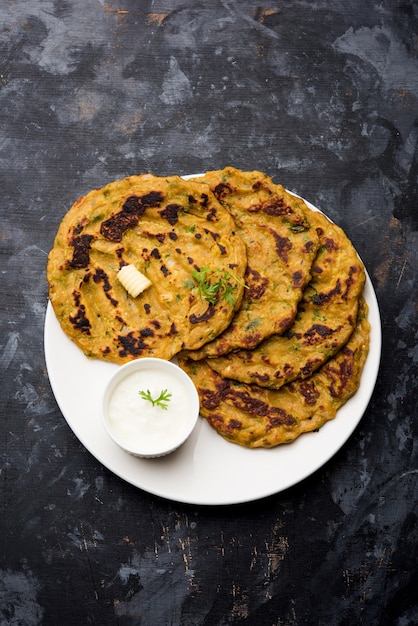 Thalipeeth is a type of savoury multi-grain pancake popular in Maharashtra, India served with curd, butter or ghee