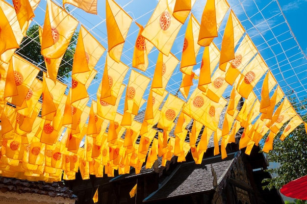 Thammachak flag yellow in temple Wat Phan tao on blue sky temple Northern Thailand