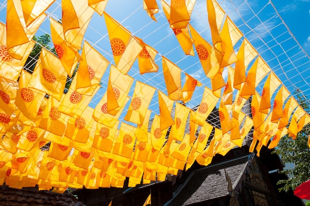 Thammachak flag yellow in temple Wat Phan tao on blue sky temple Northern Thailand