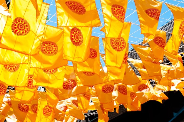 Thammachak flag yellow in temple Wat Phan tao on blue sky temple Northern Thailand