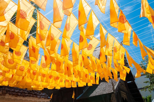 Thammachak flag yellow in temple Wat Phan tao on blue sky temple Northern Thailand