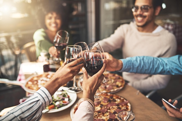 Thank you all for coming Shot of a group of cheerful young friends having a celebratory toast with wine at dinner inside of a restaurant