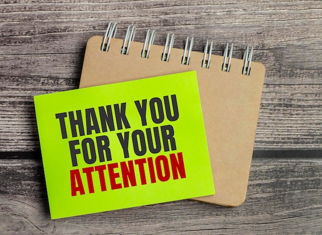 Thank Your For Your Attention wording on a green sticker and notepad