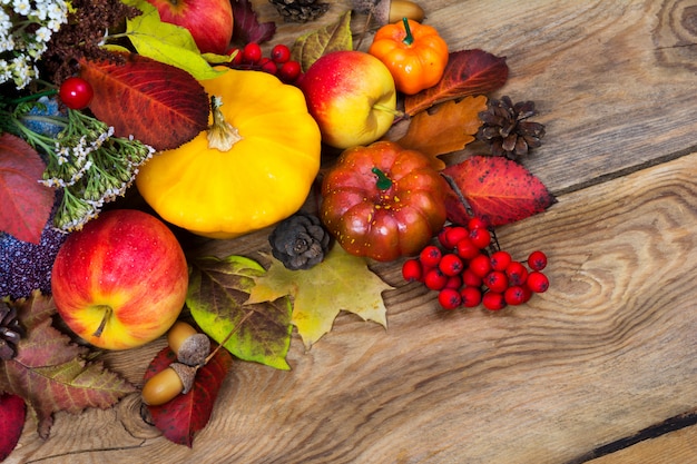 Thanksgiving arrangement with rowan, white flowers, yellow squash