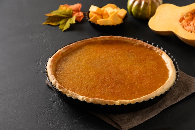 Thanksgiving Day homemade pumpkin pie with spicescinnamoncardamom ginger