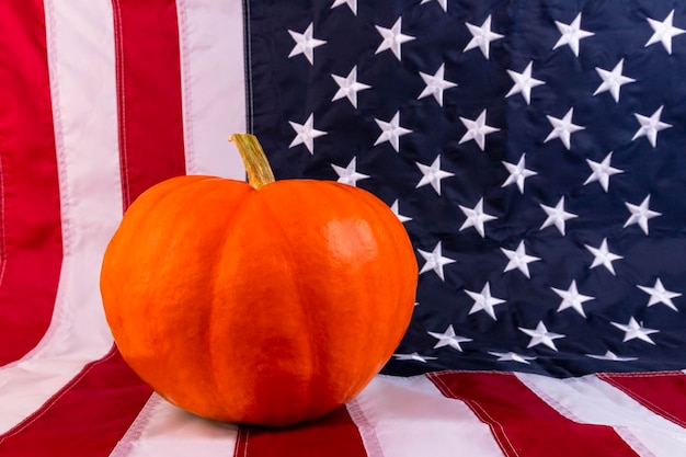 Thanksgiving Day Orange pumpkin on the background of the flag of America