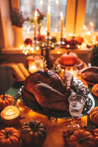 Thanksgiving holiday dinner table setting with fall decoration and pumpkins