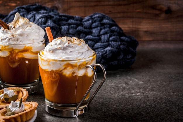 Thanksgiving Hot and spicy aromatic pumpkin latte with cinnamon with blanket