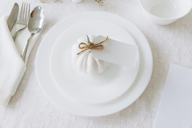 Thanksgiving table setting tableware and decorations Blank white postcard on table mockup