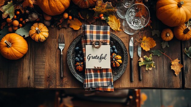 Photo thanksgiving table setting with pumpkins fall leaves and grateful place card