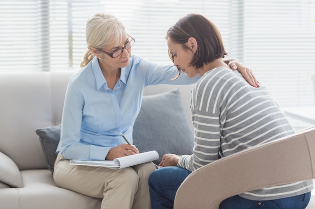 Therapist comforting woman