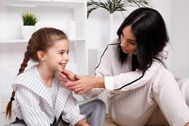 Therapist session concept. Female psychologist working with cute little child.