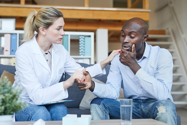 Therapist supporting patient at psychology session