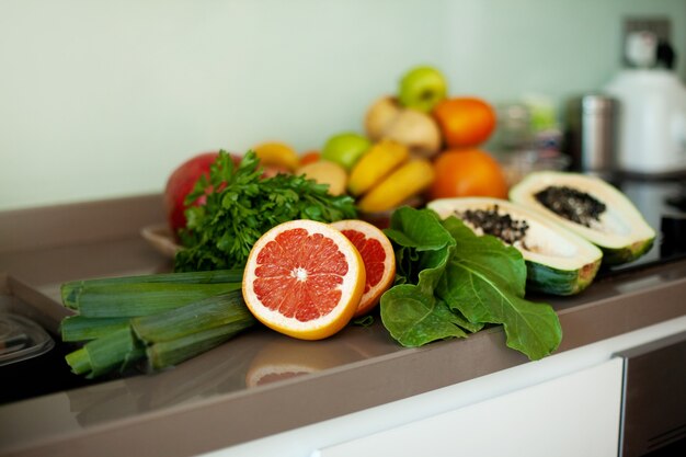 There are fresh vegetables and fruits on the table.